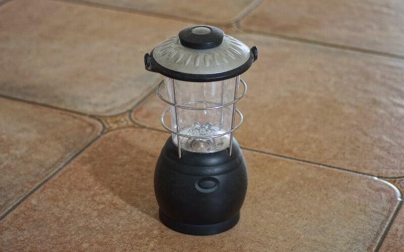 An electric lantern on tile.