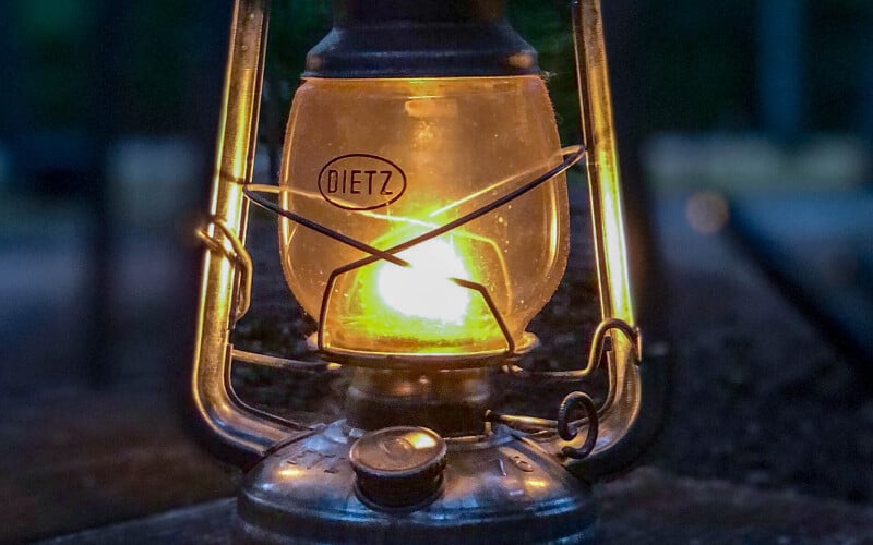 Close up of a gas-powered lantern on a table.