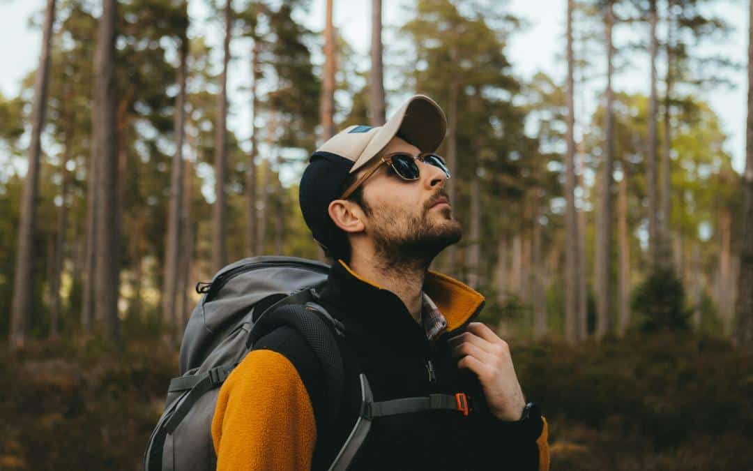 A man wearing best trekking sunglasses during a hiking trip.